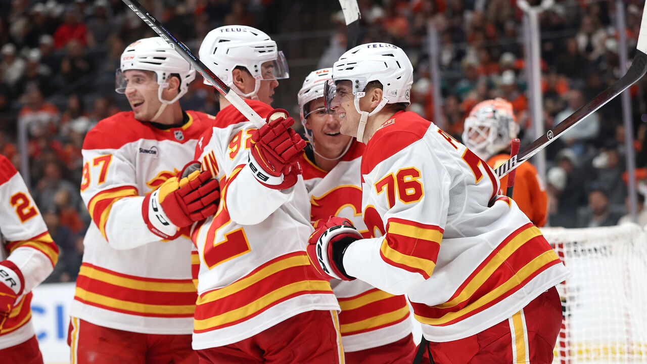 ANAHEIM, CALIFORNIA - OCTOBER 13: Yan Kuznetsov #37, Matvei Gridin #92 and Ryan Strome #22 congratulate Martin Pospisil #76 of the Calgary Flames after his goal during the third period of a game against the Anaheim Ducks at Honda Center on October 13, 2026 in Anaheim, California.