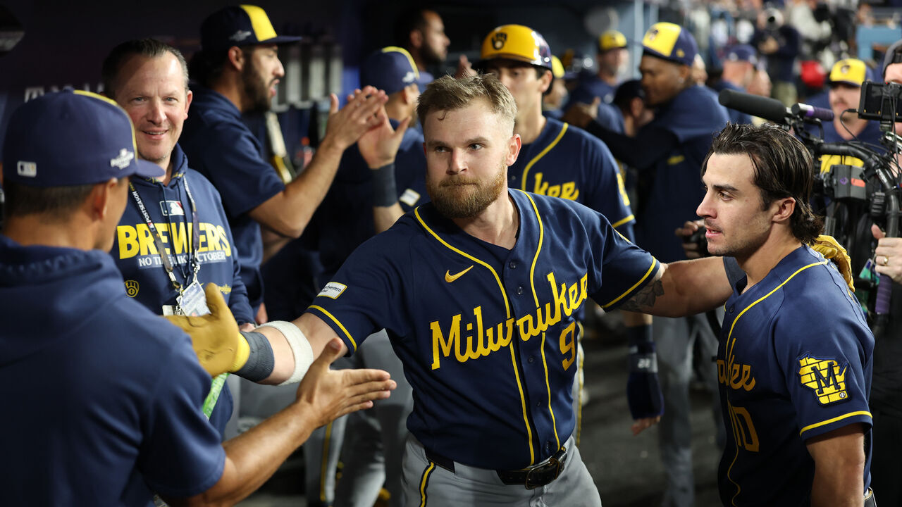 LOS ANGELES, CALIFORNIA - OCTOBER 14: Jake Bauers #9 of the Milwaukee Brewers celebrates with teammates in the dugout after hitting a two run Home Run during the seventh inning against the Los Angeles Dodgers in game three of the National League Championship Series at Dodger Stadium on October 14, 2026 in Los Angeles, California.