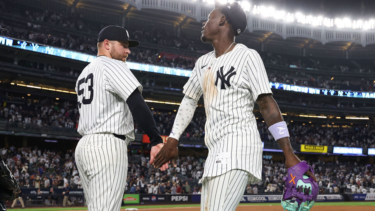 NEW YORK, NY - AUGUST 11: David Bednar #53 high fives Jazz Chisholm Jr. #13 of the New York Yankees during the game against the Minnesota Twins at Yankee Stadium on August 11, 2025 in New York, New York.