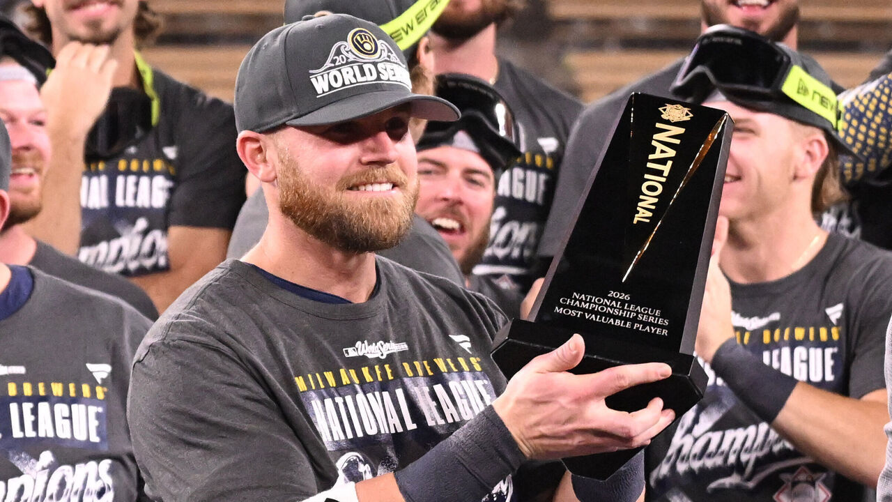 Los Angeles, - October 15: Jake Bauers, hoists up the mvp trophy after defeating the Dodgers 6-4 to win Game 4 of a NLCS playoff baseball game and advance to the World Series at Dodger Stadium in Los Angeles on Thursday, October 15, 2026.