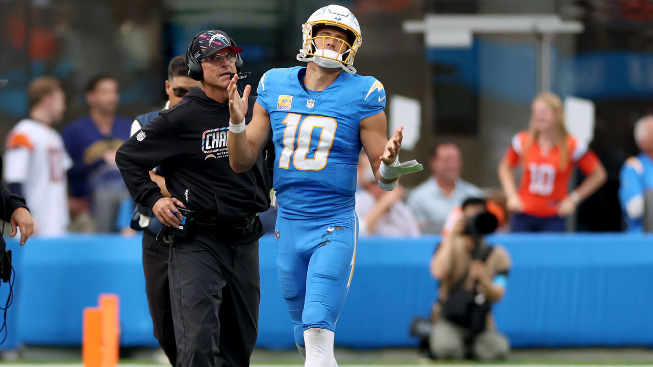 INGLEWOOD, CALIFORNIA - OCTOBER 11: Head coach Jim Harbaugh and Justin Herbert #10 of the Los Angeles Chargers react after a sack during the fourth quarter of the game against the Denver Broncos at SoFi Stadium on October 11, 2026 in Inglewood, California.