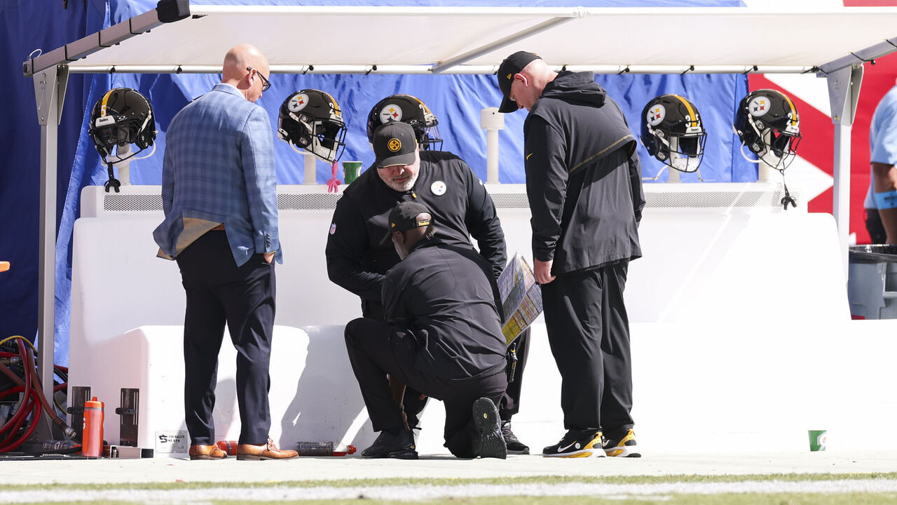 TAMPA, FLORIDA - OCTOBER 18: Head coach Mike McCarthy of the Pittsburgh Steelers is examined by a team trainer during halftime of an NFL football game against the Tampa Bay Buccaneers at Raymond James Stadium on October 18, 2026 in Tampa, Florida.