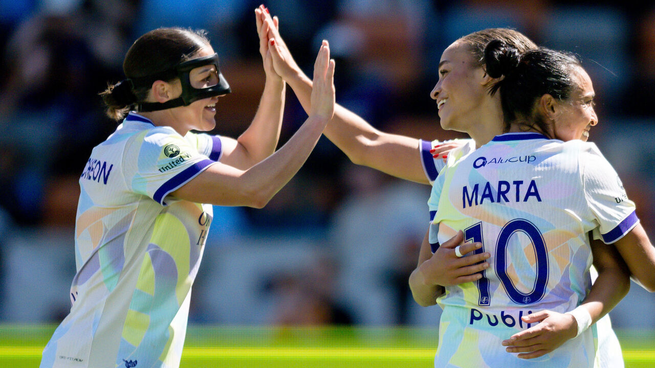 HOUSTON, TEXAS - OCTOBER 18: Teammates Haley McCutcheon #2 and Marta #10 celebrate with Solai Washington #29 of Orlando Pride after scoring the team's second goal in the first half during the NWSL match against Houston Dash at Shell Energy Stadium on October 18, 2026 in Houston, Texas.