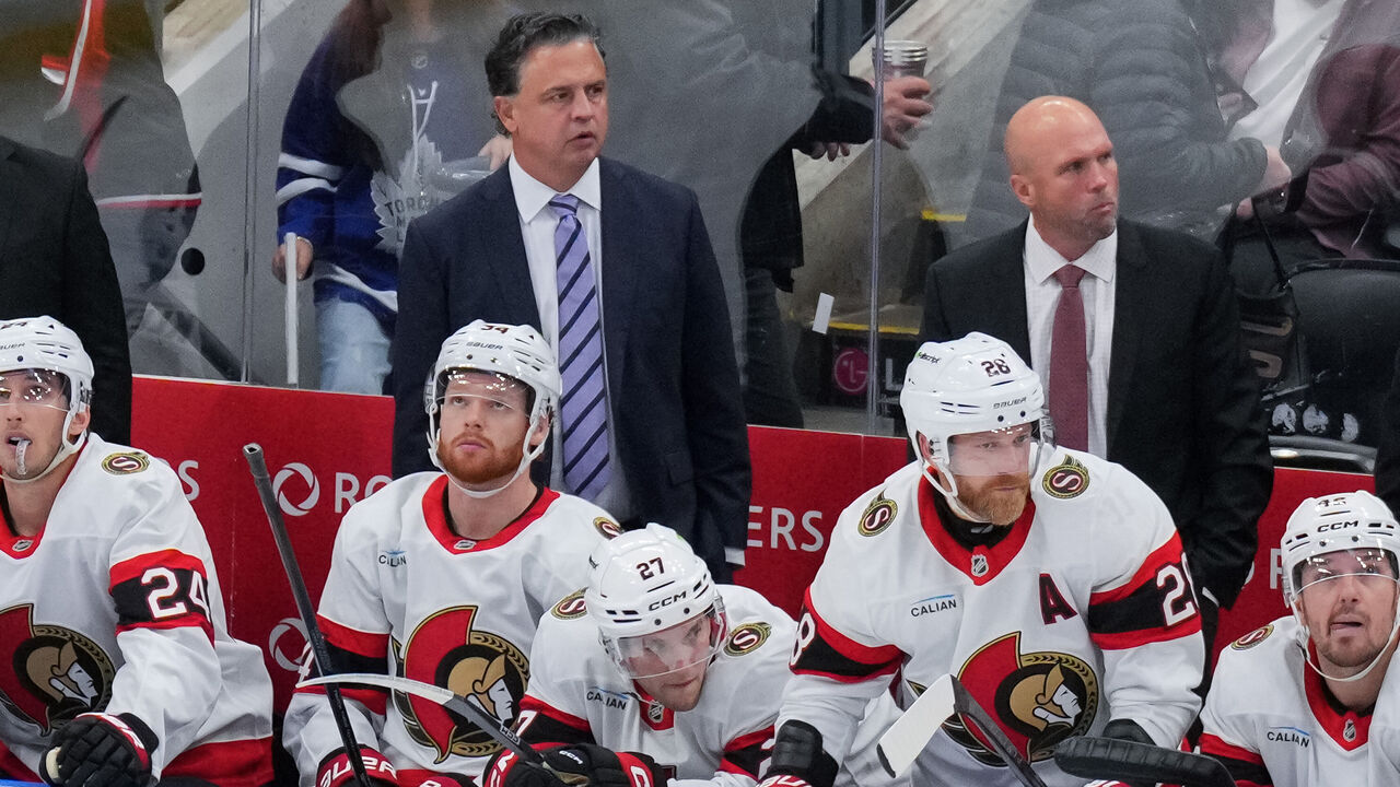 TORONTO, CANADA - OCTOBER 03: Ottawa Senators head coach, Travis Green looks on from behind the bench during his 500th career NHL game against the Toronto Maple Leafs in the third period at Scotiabank Arena on October 03, 2026 in Toronto, Ontario, Canada.