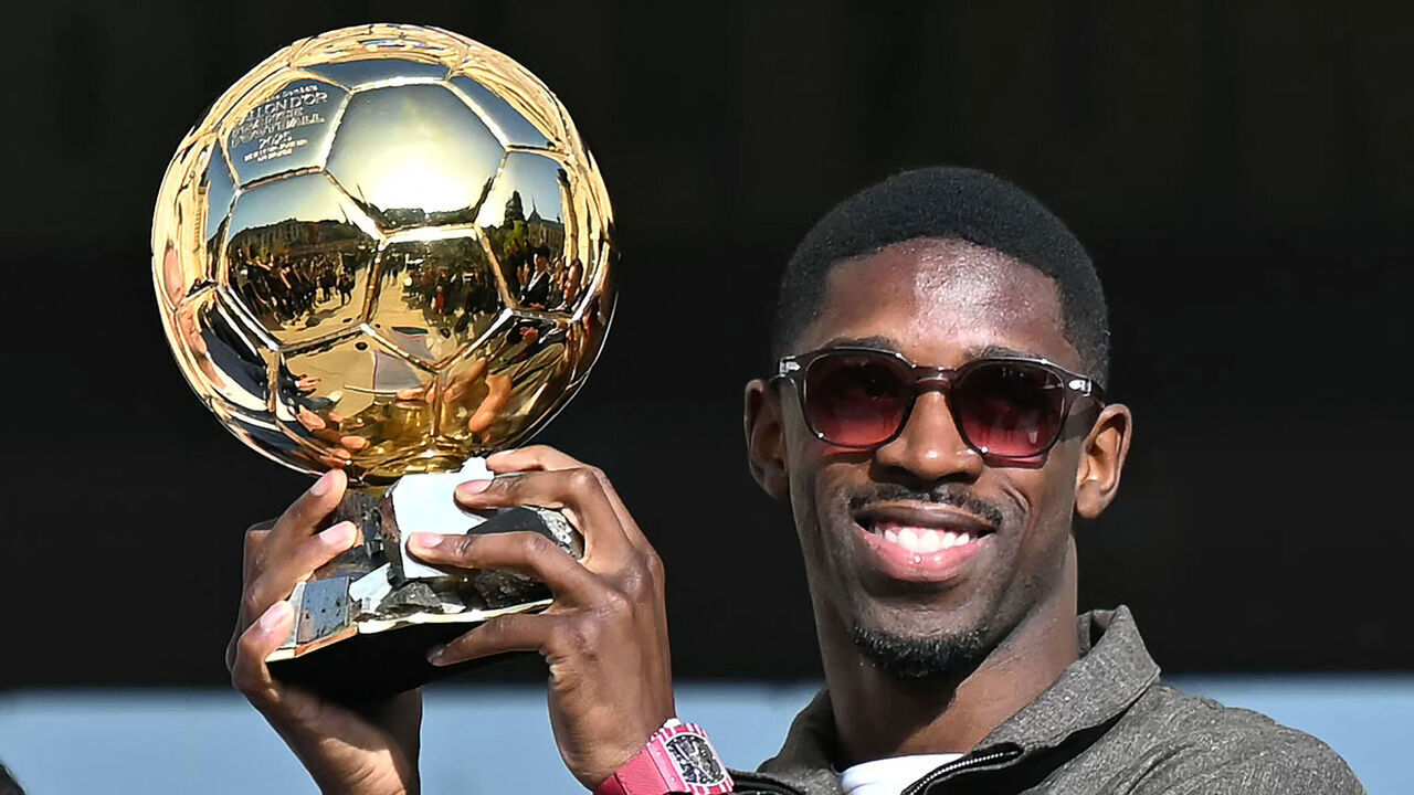 TOPSHOT - Paris Saint-Germain's French forward Ousmane Dembele holds the 2025 Ballon d'Or trophy during a presentation ceremony at the City Hall in Evreux, his hometown and where he started playing club football, on October 12, 2025.