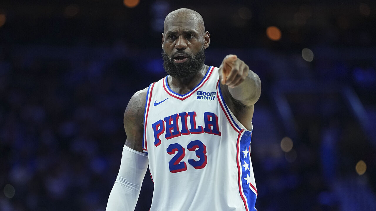 PHILADELPHIA, PENNSYLVANIA - OCTOBER 16: LeBron James #23 of the Philadelphia 76ers points against the Boston Celtics during the preseason game at Xfinity Mobile Arena on October 16, 2026 in Philadelphia, Pennsylvania.