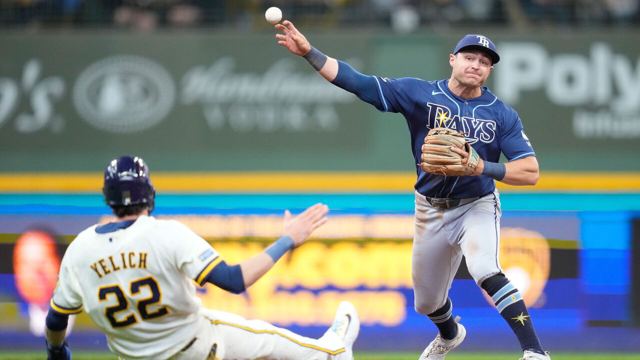 MILWAUKEE, WISCONSIN - APRIL 01: Ben Williamson #15 of the Tampa Bay Rays turns a double play as Christian Yelich #22 of the Milwaukee Brewers slides into second base in the sixth inning at American Family Field on April 01, 2026 in Milwaukee, Wisconsin.