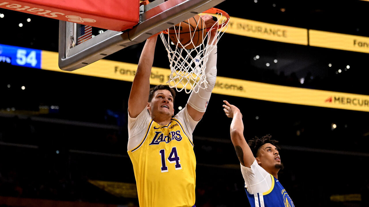Los Angeles, - October 21: Center Walker Kessler #14 of the Los Angeles Lakers slamdunks over forward Yaxel Lendeborg #1 of the Golden State Warriors in the second half of a NBA playoff basketball game at Crypto.com Arena in Los Angeles on Wednesday, October 21, 2026.
