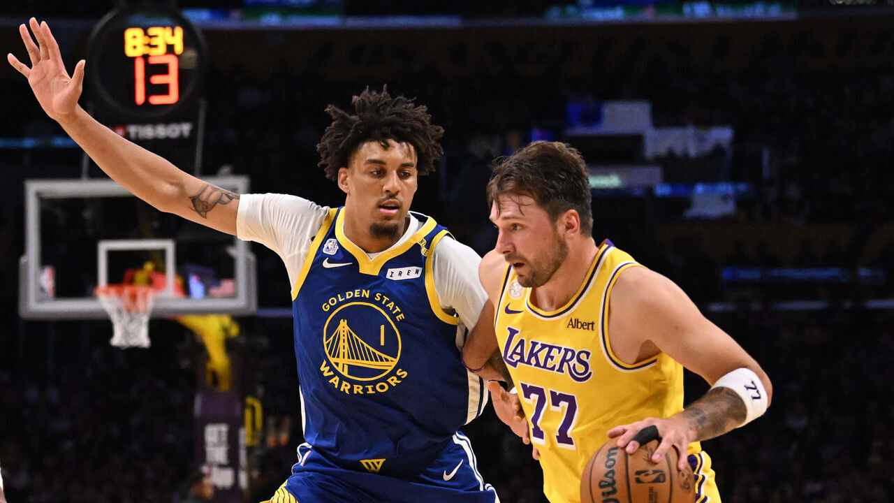 Los Angeles, - October 21: Guard Luka Doncic #77 of the Los Angeles Lakers drives to the basket against forward Yaxel Lendeborg #1 of the Golden State Warriors in the second half of a NBA playoff basketball game at Crypto.com Arena in Los Angeles on Wednesday, October 21, 2026.