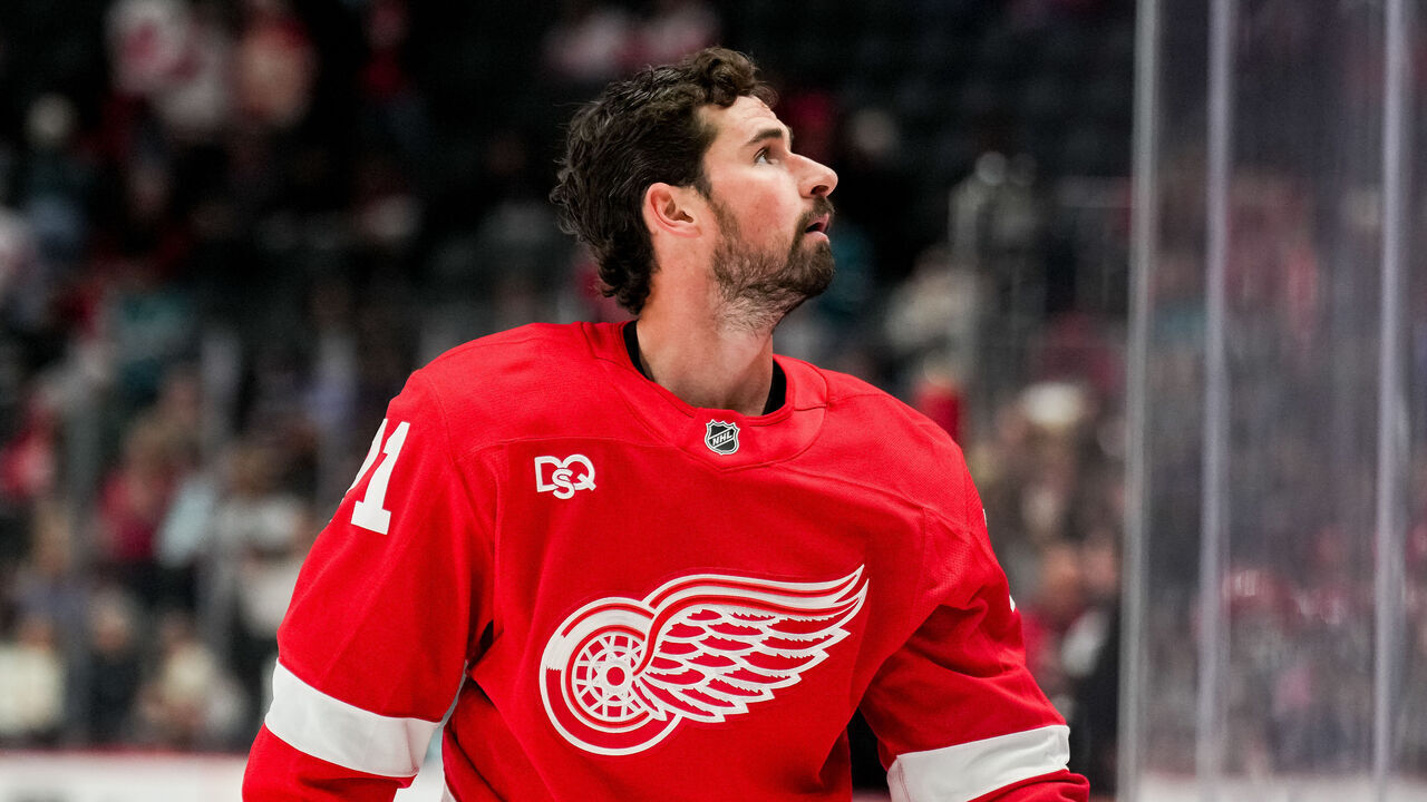 DETROIT, MICHIGAN - OCTOBER 17: Dylan Larkin #71 of the Detroit Red Wings throws a puck to fans against the San Jose Sharks during warmups at Little Caesars Arena on October 17, 2026 in Detroit, Michigan.