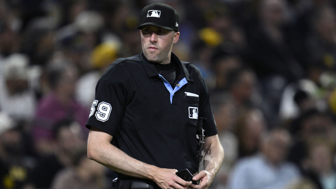 SAN DIEGO, CALIFORNIA - APRIL 09: Home plate umpire Nic Lentz #59 looks on during the fourth inning of the game between the San Diego Padres and the Colorado Rockies at Petco Park on April 09, 2026 in San Diego, California.