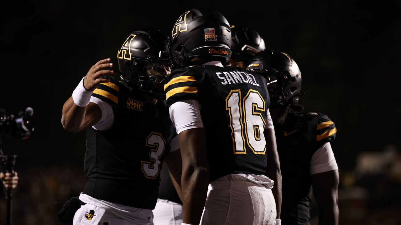 BOONE, NORTH CAROLINA - OCTOBER 22: Quarterback Malachi Singleton #3 and receiver Alexander Sanchez #16 of the Appalachian State Mountaineers celebrate a touchdown during the first half against the James Madison Dukes at Kidd Brewer Stadium on October 22, 2026 in Boone, North Carolina.