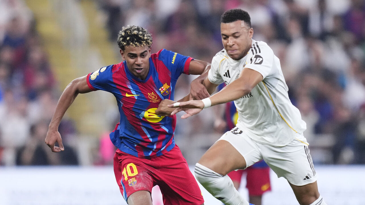 Lamine Yamal right winger of Barcelona and Spain and Kylian Mbappe centre-forward of Real Madrid and France compete for the ball during the Spanish Super Cup final match between FC Barcelona and Real Madrid at King Abdullah Sports City Hall Stadium on January 11, 2026 in Jeddah, Saudi Arabia.
