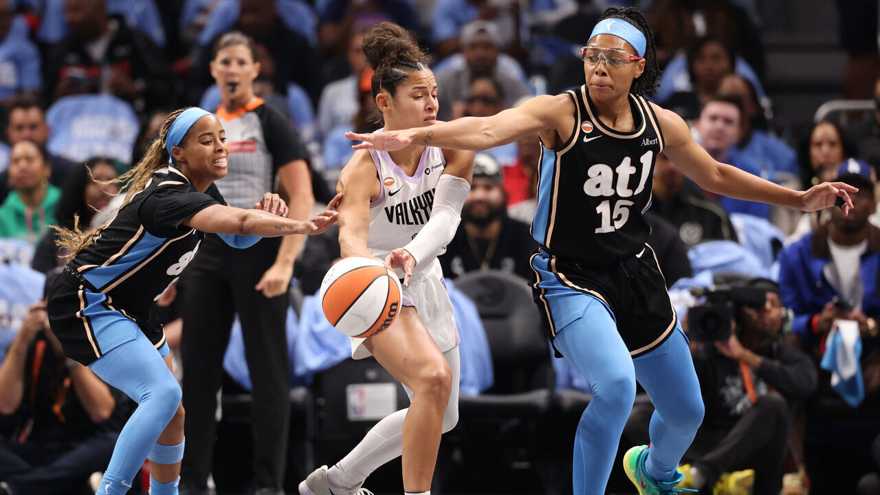 ATLANTA, GEORGIA - OCTOBER 21: Veronica Burton #22 of the Golden State Valkyries looks to pass the ball between Jordin Canada #3 and Allisha Gray #15 of the Atlanta Dream during the first quarter in game three of the WNBA Finals at State Farm Arena on October 21, 2026 in Atlanta, Georgia.