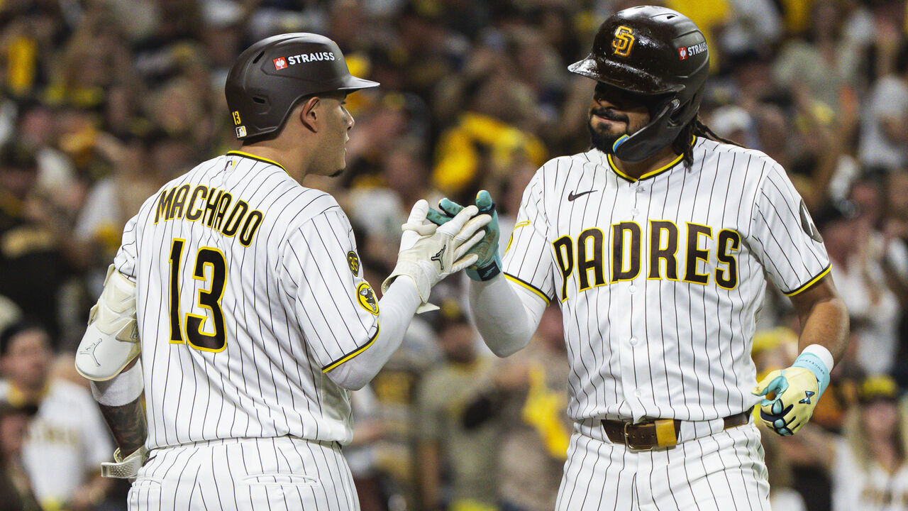 SAN DIEGO, CALIFORNIA - OCTOBER 7: Fernando Tatis Jr. #23 celebrates with Manny Machado #13 of the San Diego Padres after hitting a home run in the third inning during Game Four of the National League Division Series against the Milwaukee Brewers at Petco Park on October 7, 2026 in San Diego, California.