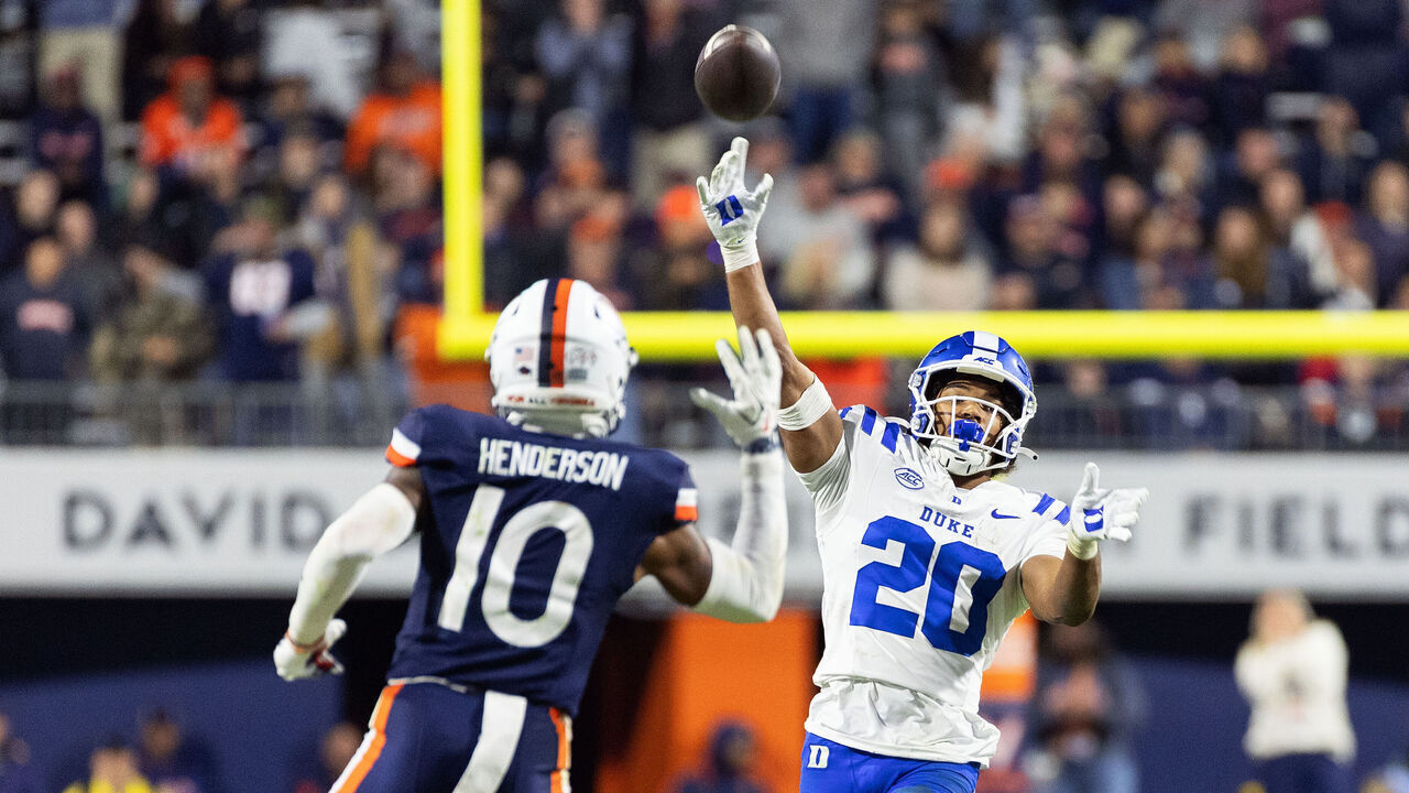 CHARLOTTESVILLE, VIRGINIA - OCTOBER 23: Nate Sheppard #20 of the Duke Blue Devils throws a touchdown pass over Jacobie Henderson #10 of the Virginia Cavaliers in the second half during a game at Scott Stadium on October 23, 2026 in Charlottesville, Virginia.