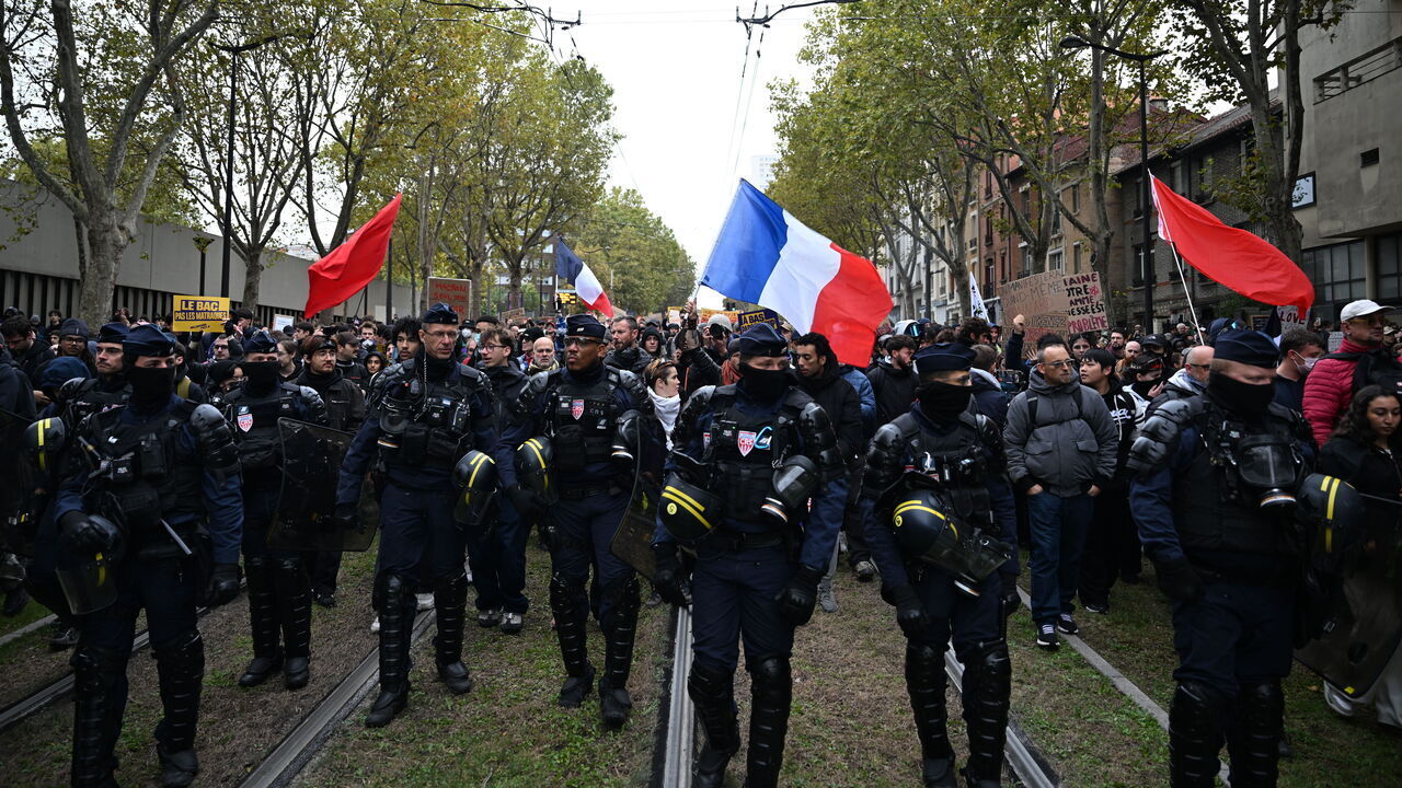 PARIS, FRANCE - OCTOBER 24: Demonstrators gather near Porte d'Italie in southern Paris, chanting slogans ahead of planned marches, while security forces closely monitor the area in Paris, France, on October 24, 2026.