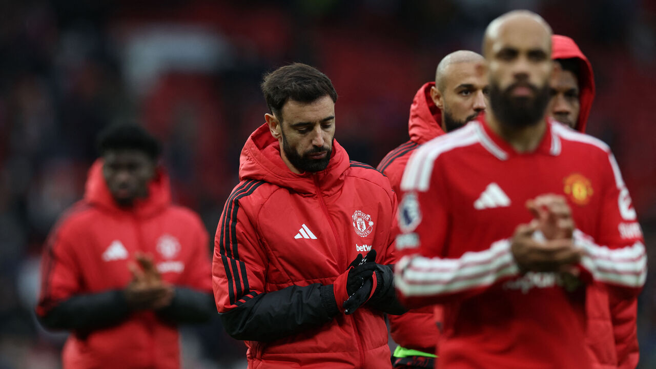 Manchester United's Portuguese midfielder #08 Bruno Fernandes (C) reacts to their defeat on the pitch after the English Premier League football match between Manchester United and Bournemouth at Old Trafford in Manchester, north west England, on October 25, 2026. Bournemouth won the game 3-0. / RESTRICTED TO EDITORIAL USE. No use with unauthorized audio, video, data, fixture lists, club/league logos or 'live' services. Online in-match use limited to 120 images. An additional 40 images may be used in extra time. No video emulation. Social media in-match use limited to 120 images. An additional 40 images may be used in extra time. No use in betting publications, games or single club/league/player publications. /