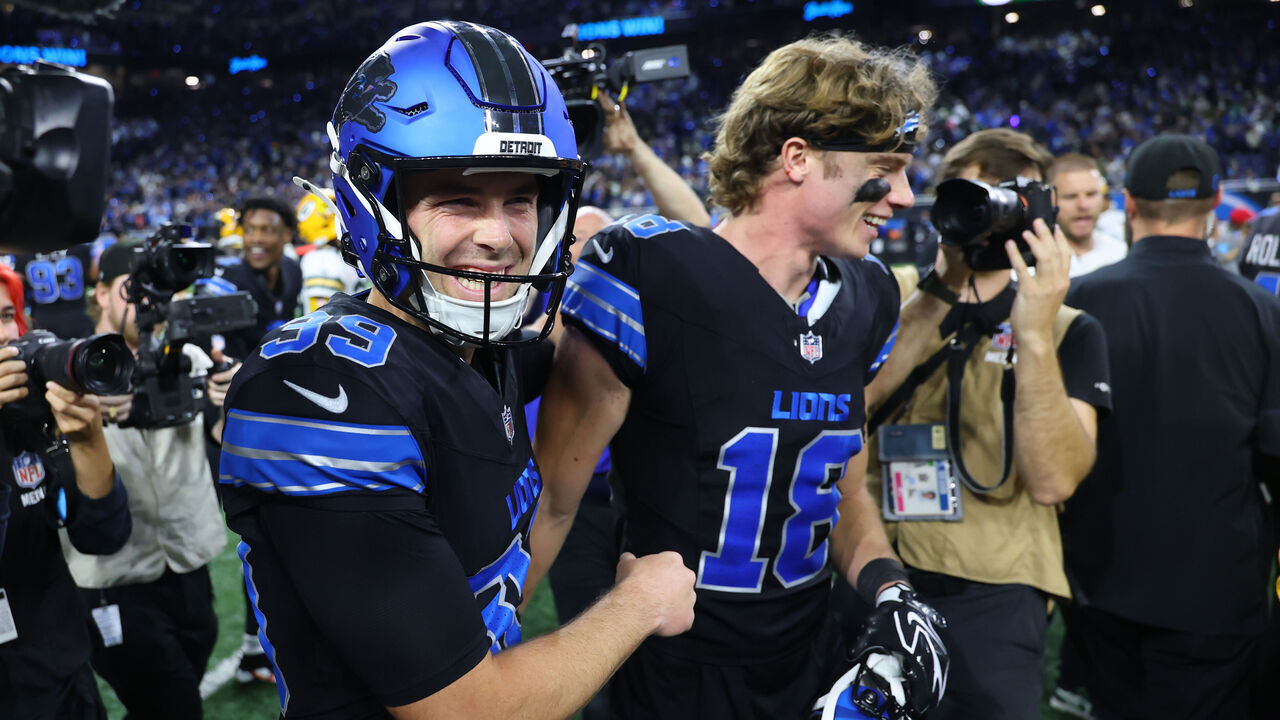 DETROIT, MICHIGAN - OCTOBER 25: Jake Bates #39 of the Detroit Lions celebrates with Isaac TeSlaa #18 after kicking a game-winning field goal against the Green Bay Packers at Ford Field on October 25, 2026 in Detroit, Michigan.
