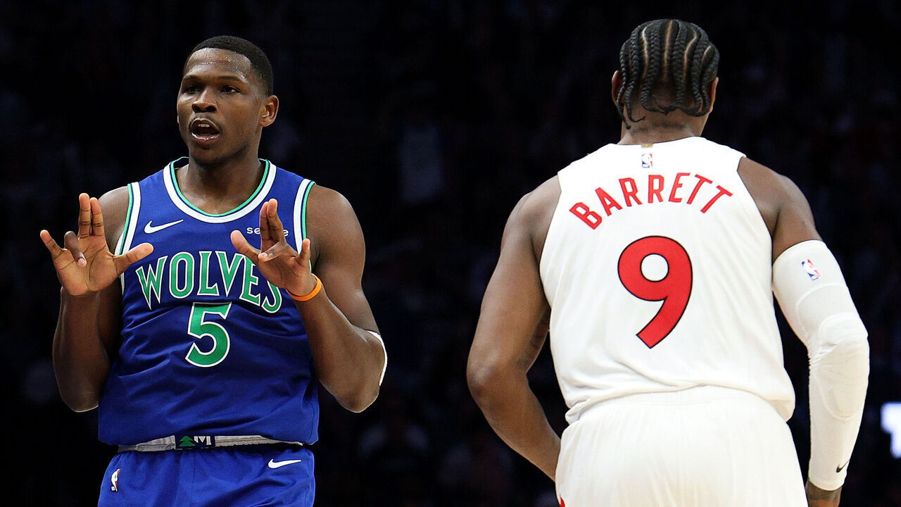 MINNEAPOLIS, MINNESOTA - OCTOBER 25: Anthony Edwards #5 of the Minnesota Timberwolves celebrates his three-point basket as RJ Barrett #9 of the Toronto Raptors looks on in the third quarter during the home opener at Target Center on October 25, 2026 in Minneapolis, Minnesota. The Timberwolves defeated the Raptors 117-94.