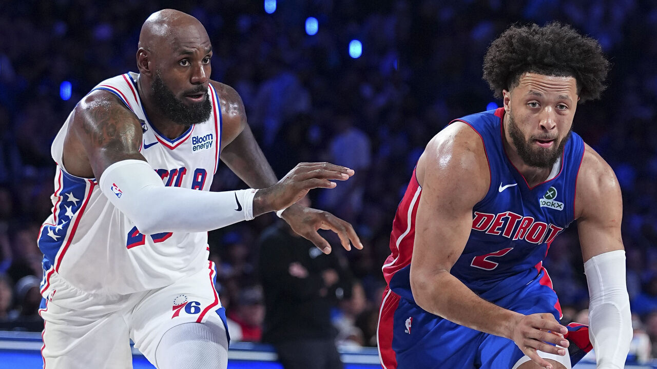 PHILADELPHIA, PENNSYLVANIA - OCTOBER 25: Cade Cunningham #2 of the Detroit Pistons drives to the basket against LeBron James #23 of the Philadelphia 76ers in the third quarter at Xfinity Mobile Arena on October 25, 2026 in Philadelphia, Pennsylvania. The Pistons defeated the 76ers 106-93.