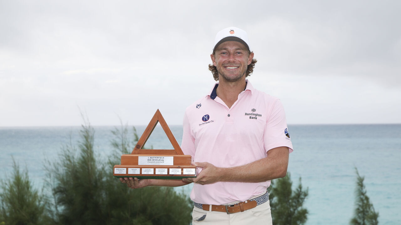 SOUTHAMPTON, BERMUDA - OCTOBER 26: Austin Smotherman of the United States celebrates with the trophy after a sudden death playoff following the weather cancelled final round of the Butterfield Bermuda Championship 2026 at Port Royal Golf Course on October 26, 2026 in Southampton, Bermuda.