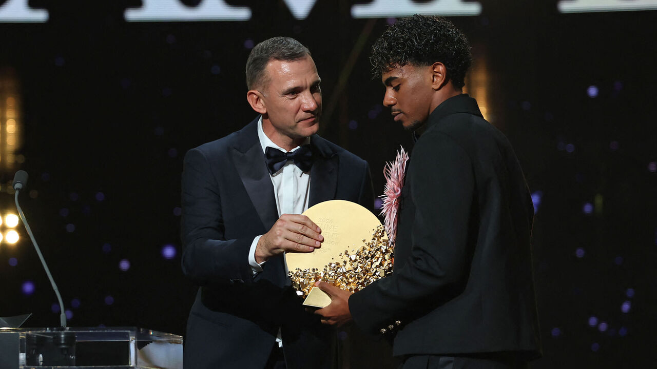 Former Ukraine forward Andriy Shevchenko presents the Trophy for the Men's Young Talent of the Year to Spain and Barcelona forward Lamine Yamal during the 2026 Ballon d'Or France Football award ceremony at the Palladium Theatre in London on October 26, 2026.