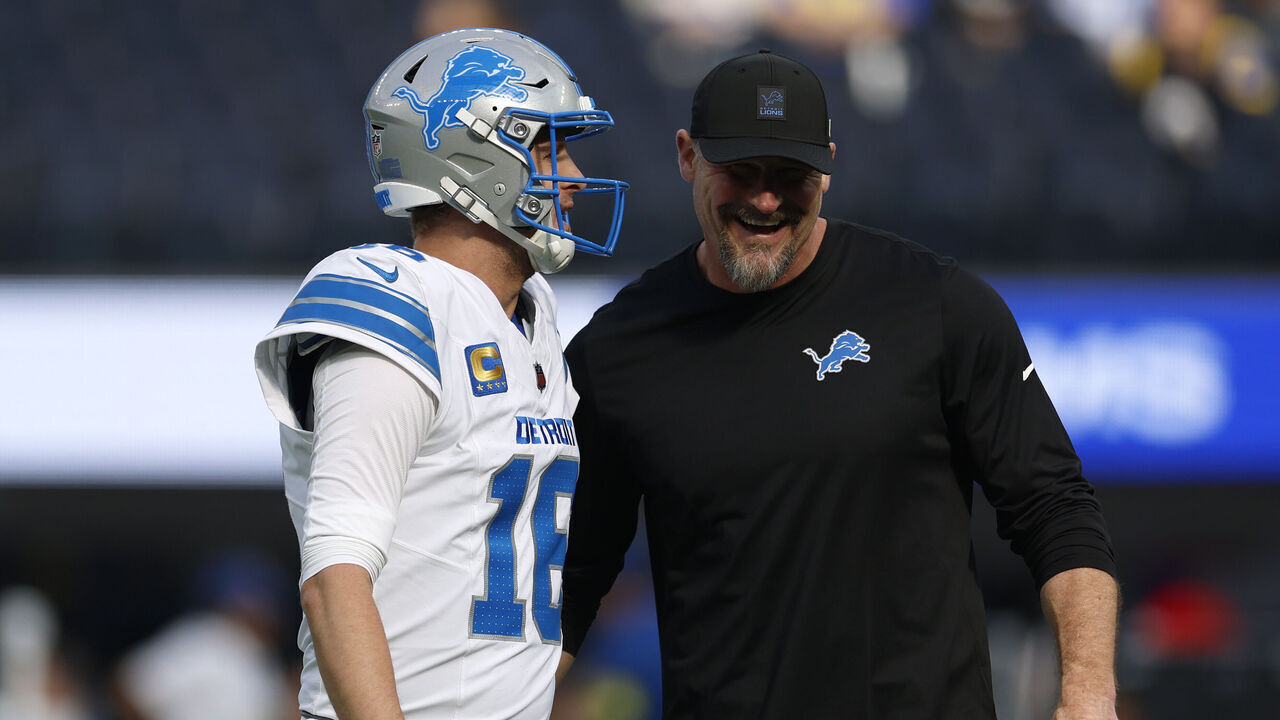 INGLEWOOD, CALIFORNIA - DECEMBER 14: Jared Goff #16 and Head coach Dan Campbell of the Detroit Lions talk before the game against the Los Angeles Rams at SoFi Stadium on December 14, 2025 in Inglewood, California.