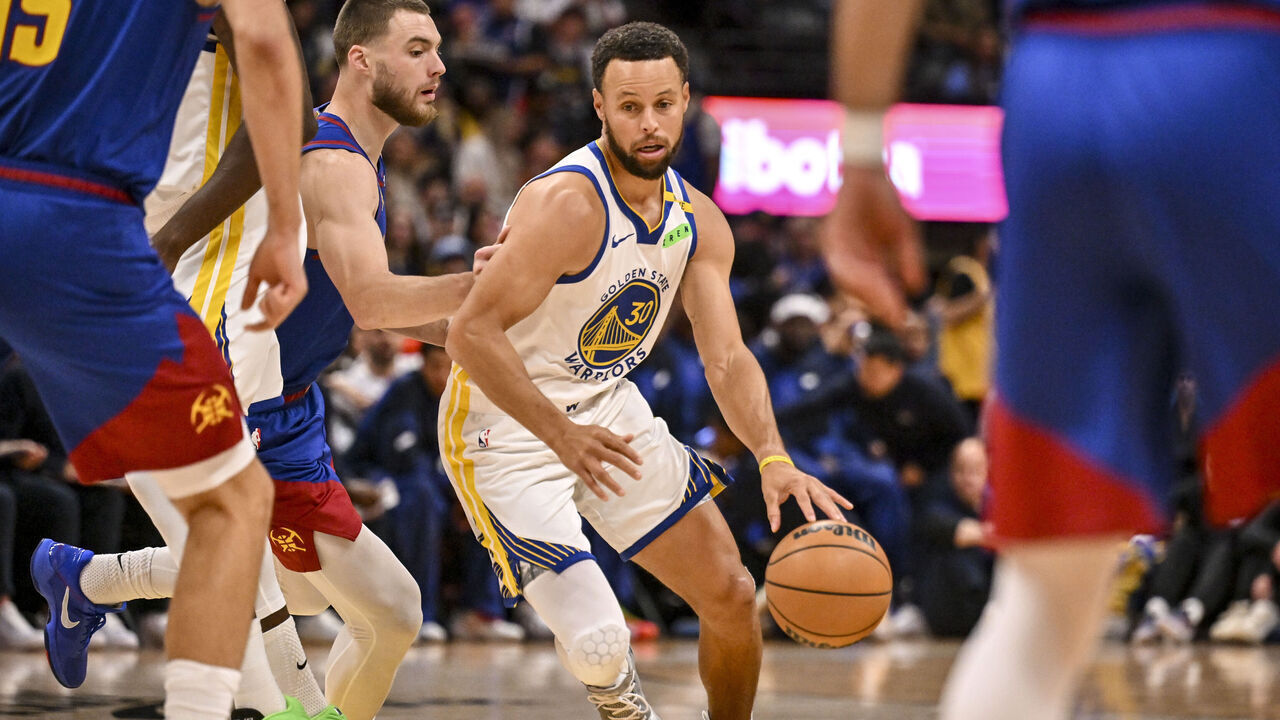 DENVER , CO - OCTOBER 26: Christian Braun (0) of the Denver Nuggets defends Stephen Curry (30) of the Golden State Warriors during the first quarter at Ball Arena in Denver, Colorado on Monday, October 26, 2026.