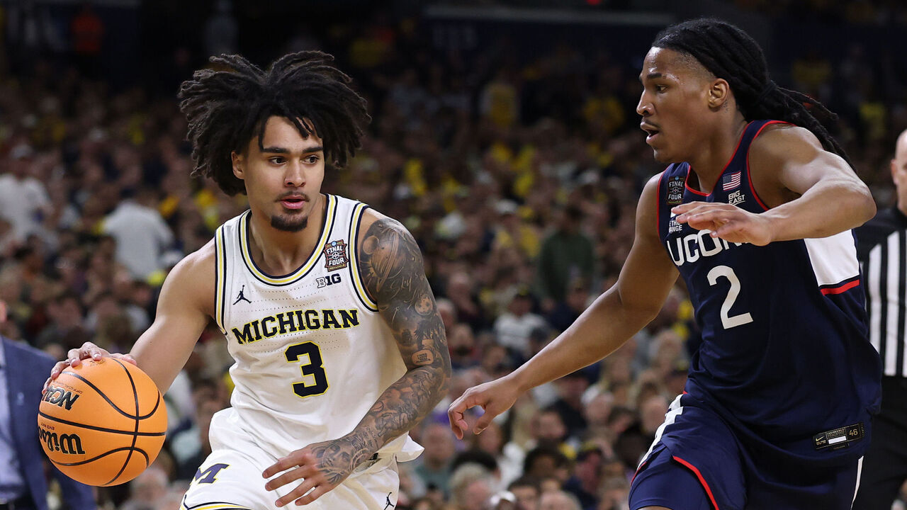 INDIANAPOLIS, INDIANA - APRIL 06: Elliot Cadeau #3 of the Michigan Wolverines drives around Silas Demary Jr. #2 of the UConn Huskies during the first half of a game in the National Championship of the 2026 NCAA Men's Basketball Tournament at Lucas Oil Stadium on April 06, 2026 in Indianapolis, Indiana.