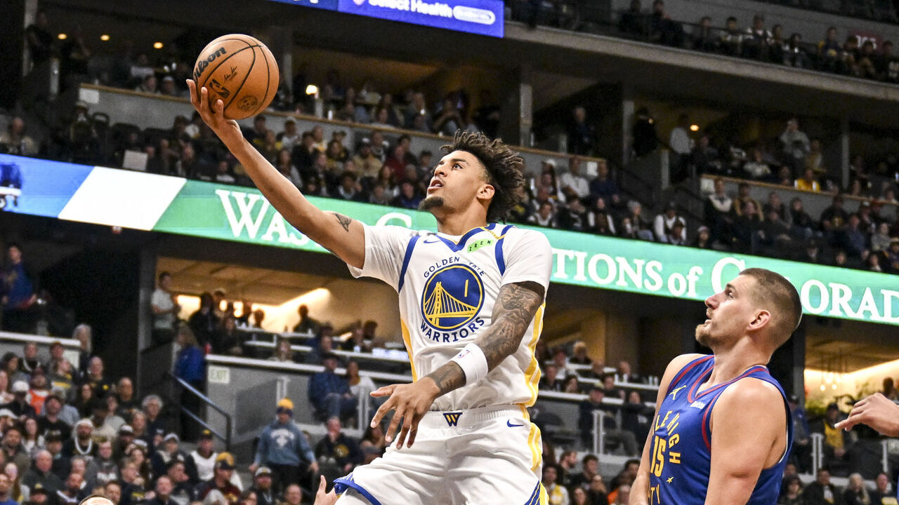 DENVER , CO - OCTOBER 26: Yaxel Lendeborg (1) of the Golden State Warriors scores as Trevon Brazile (7), Nikola Jokic (15) and Jamal Murray (27) of the Denver Nuggets watch during the first quarter at Ball Arena in Denver, Colorado on Monday, October 26, 2026.