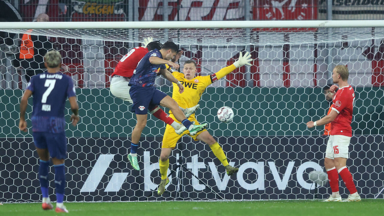 ESSEN, GERMANY - OCTOBER 27: Christoph Baumgartner of RB Leipzig scores his team’s second goal under pressure from Franci Bouebari of Rot-Weiss Essen during the DFB Cup 2026/27 match between Rot-Weiss Essen and RB Leipzig at Stadion an der Hafenstrasse on October 27, 2026 in Essen, Germany.