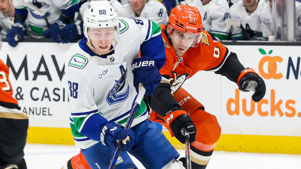 ANAHEIM, CA - OCTOBER 27: Jonathan Lekkerimaki #88 of the Vancouver Canucks skates with the puck with pressure from Cutter Gauthier #61 of the Anaheim Ducks during the second period of the game at Honda Center on October 27, 2026 in Anaheim, California.