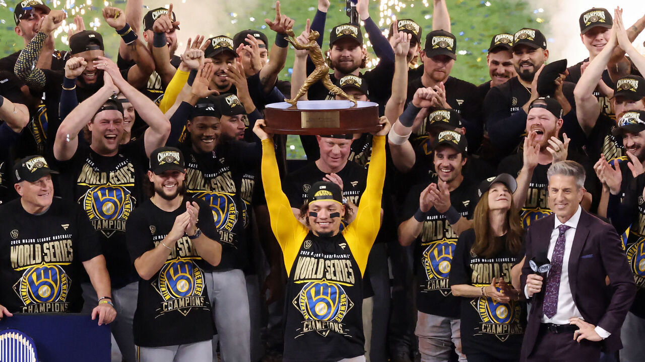 ST PETERSBURG, FLORIDA - OCTOBER 28: The Milwaukee Brewers celebrate as William Contreras #24 poses with the Willie Mays World Series Most Valuable Player award after defeating the Tampa Bay Rays in the 2026 World Series at Tropicana Field on October 28, 2026 in St Petersburg, Florida.