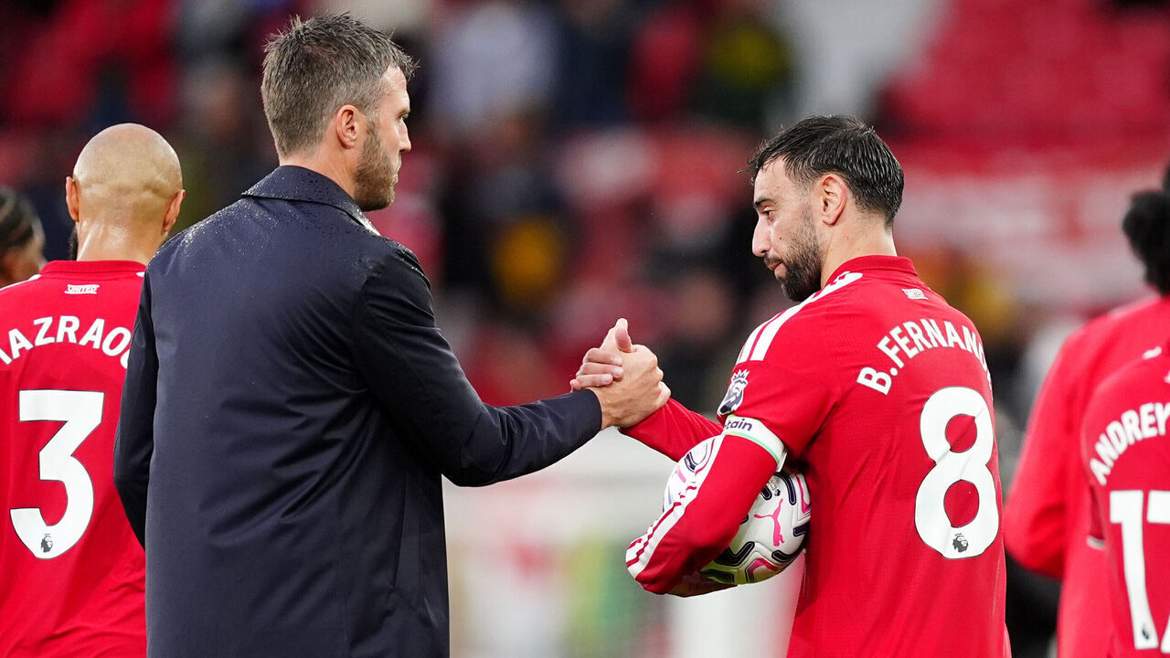 Manchester United's Bruno Fernandes (right) leaves the pitch with the match ball after scoring a hat-trick alongside manager Michael Carrick following the Premier League match at Old Trafford, Manchester. Picture date: Sunday August 30, 2026.