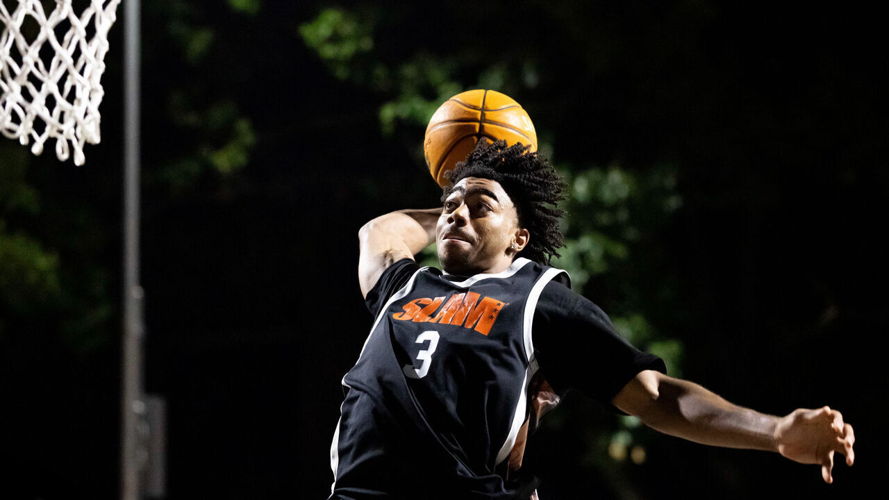 NEW YORK, NEW YORK - AUGUST 17: Class of 2027 high school basketball recruit Reese Alston #3 dunks during the SLAM Summer Classic at Rucker Park on August 17, 2026 in New York City.