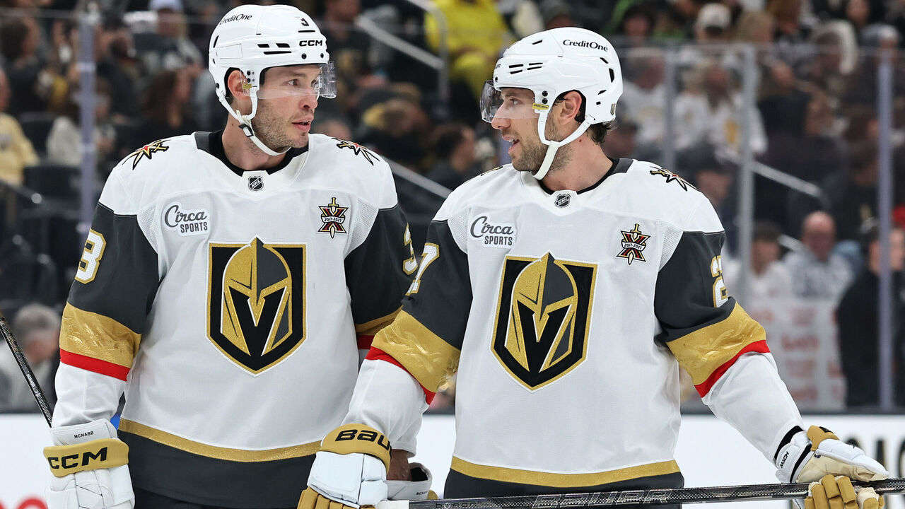 LAS VEGAS, NEVADA - OCTOBER 30: Brayden McNabb #3 of the Vegas Golden Knights, playing in his 900th career NHL game, talks with Shea Theodore #27 during a stoppage in play in the second period of a game against the New Jersey Devils at T-Mobile Arena on October 30, 2026 in Las Vegas, Nevada. The Devils defeated the Golden Knights 5-2.