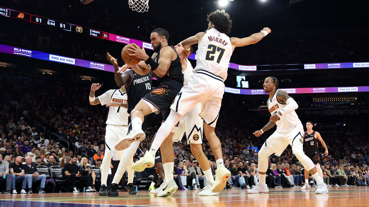 PHOENIX, ARIZONA - OCTOBER 30: Dillon Brooks #3 of the Phoenix Suns controls a rebound against Jamal Murray #27 of the Denver Nuggets during the first half of the Emirates NBA Cup game at Mortgage Matchup Center on October 30, 2026 in Phoenix, Arizona.