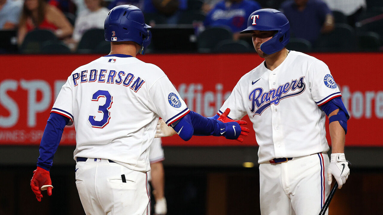 ARLINGTON, TEXAS - APRIL 27: Joc Pederson #3 of the Texas Rangers celebrates with Kyle Higashioka #11 after hitting a solo home run against the New York Yankees in the seventh inning at Globe Life Field on April 27, 2026 in Arlington, Texas.