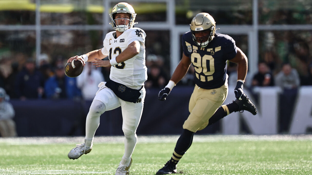 FOXBOROUGH, MA - OCTOBER 31: CJ Carr #13 of the Notre Dame Fighting Irish looks to pass while being chased by Ikenna Ozurumba #90 of the Navy Midshipmen during the second half at Gillette Stadium on October 31, 2026 in Foxborough, Massachusetts.